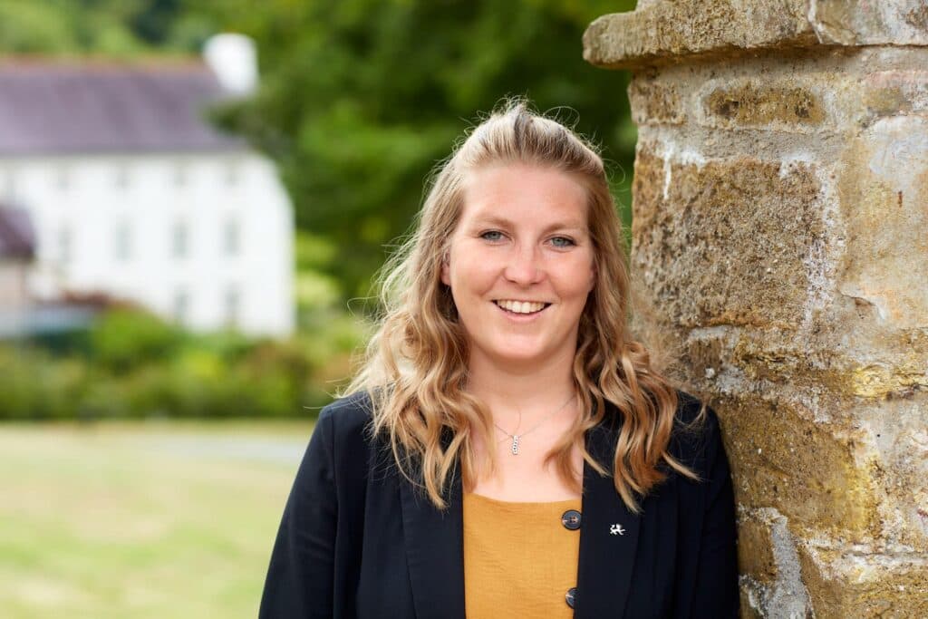 smiling lady outside of grove