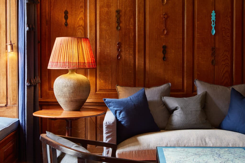 a comfortable sofa spot with pillows and lamp