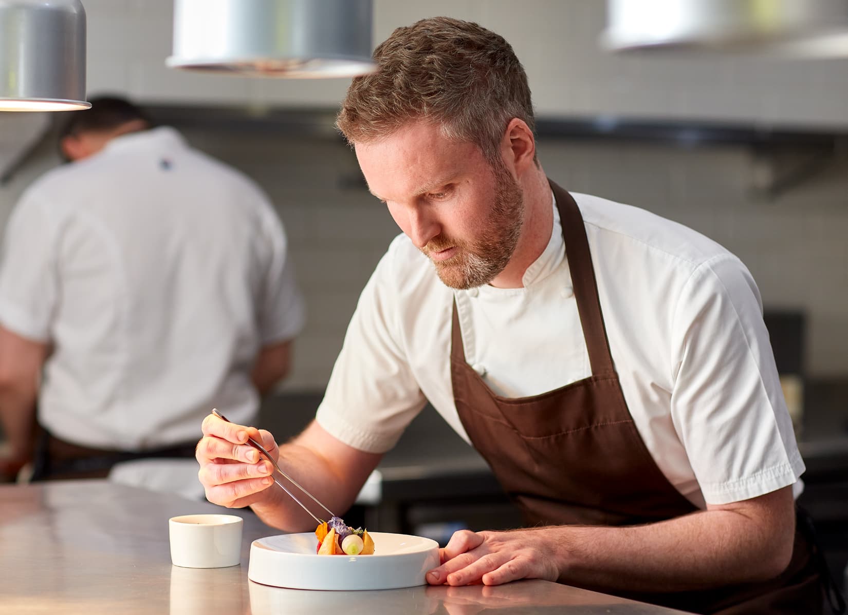 chefs in the kitchen, decorating dessert