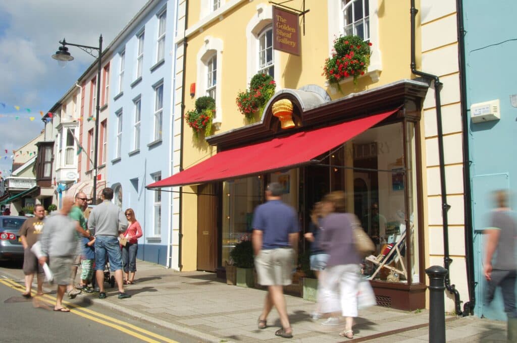 people walking past the golden sheaf gallery