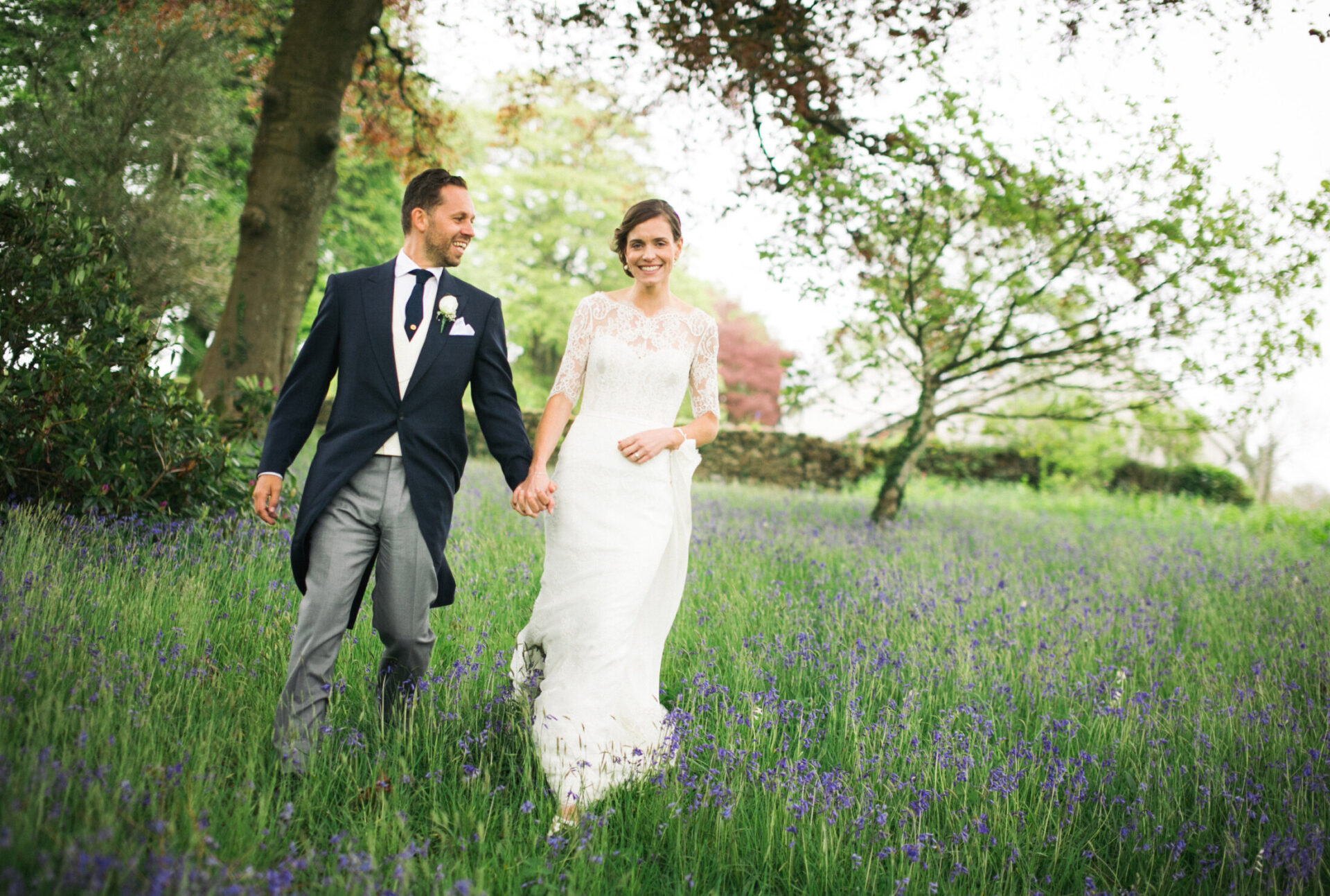 bride and groom walking through flowers